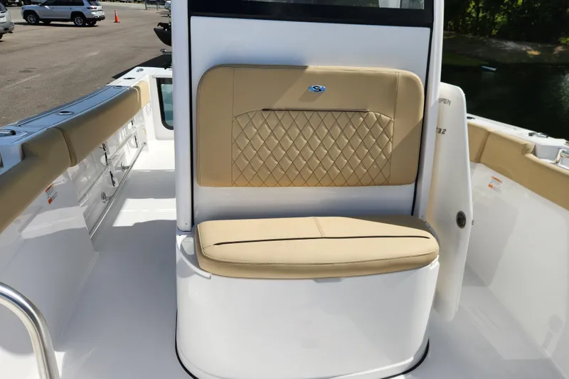 Slide: The Image of 2026 Sportsman Open 232 Center Console boat interior with tan cushioned seating. - 10
