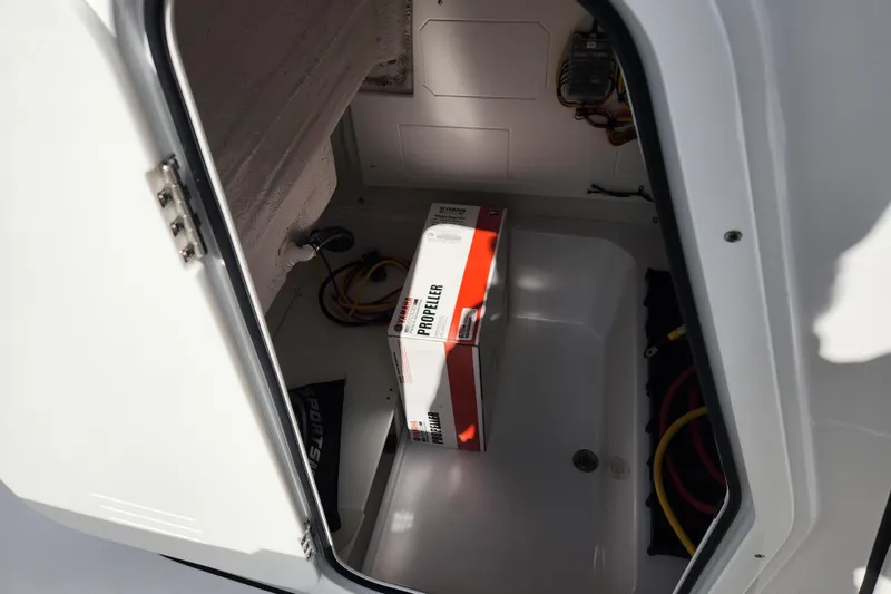 Slide: The Image of Storage compartment of 2026 Sportsman Open 232 Center Console with propeller box inside. - 13