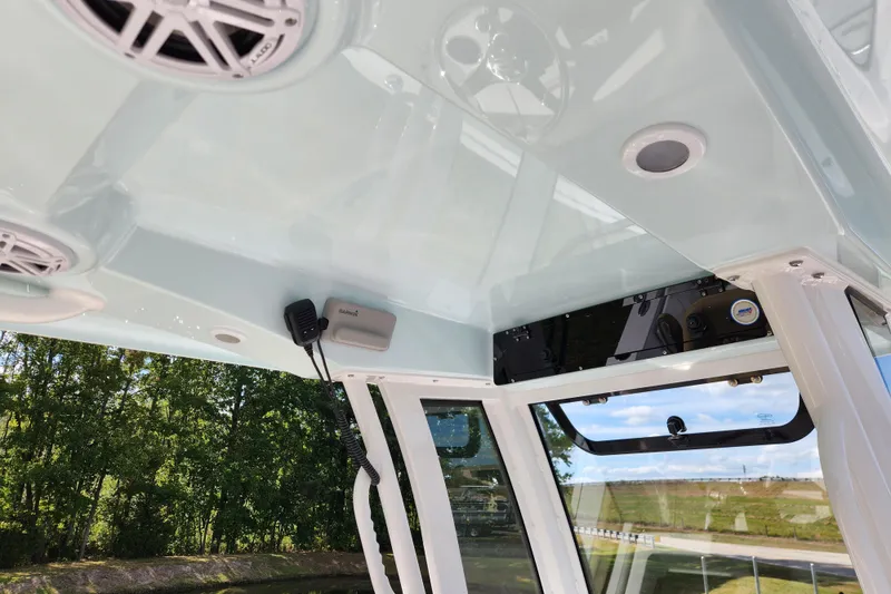 Slide: The Image of 2026 Sportsman Open 232 Center Console interior with speakers and communication equipment. - 14