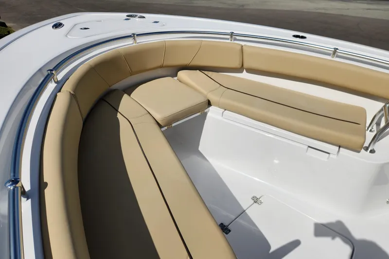 Slide: The Image of 2026 Sportsman Open 232 Center Console boat with tan cushioned seating. - 9
