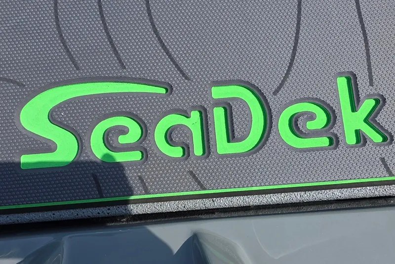 Slide: The Image of SeaDek logo on Xpress XR21 boat, 2026 model, featuring green and gray design. - 12