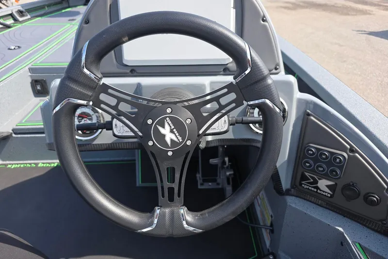 Slide: The Image of Steering wheel of 2026 Xpress XR21 boat with control panel and dashboard. - 22