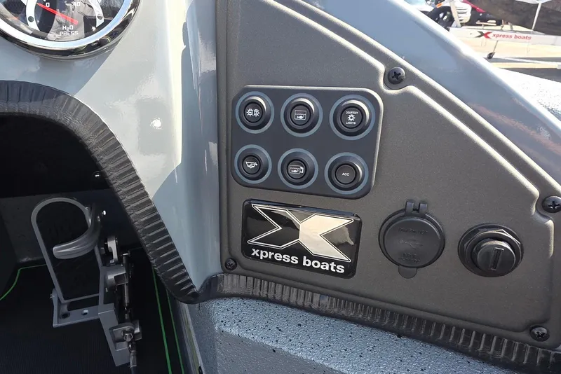 Slide: The Image of Control panel of 2026 Xpress XR21 boat with switches and logo. - 24