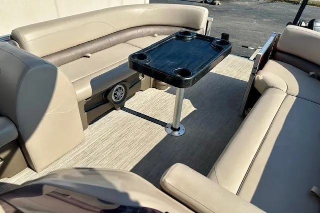 Slide: The Image of Interior of 2020 Avalon 220 Cruise pontoon boat with beige seating and black table. - 11