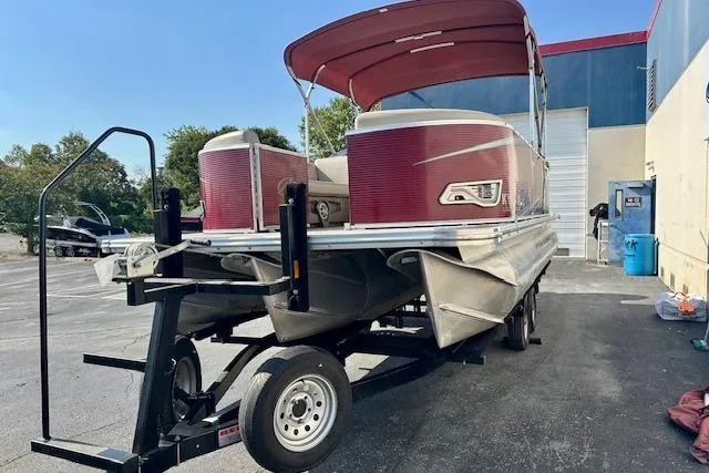 Slide: The Image of 2020 Avalon 220 Cruise pontoon boat on trailer, red canopy, parked outdoors. - 3