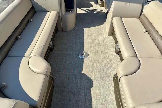 Slide: The Image of Interior of a 2020 Avalon 220 Cruise boat with beige seating and carpeted floor. - 5
