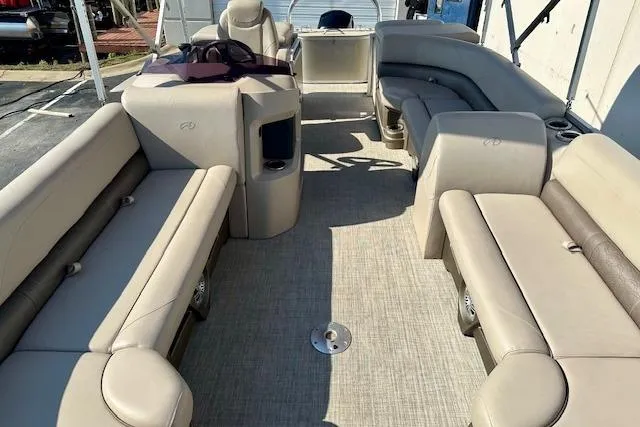 Slide: The Image of 2020 Avalon 220 Cruise pontoon boat interior with beige seating and spacious layout. - 6