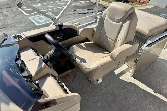 Slide: The Image of 2020 Avalon 220 Cruise boat interior with beige captain's chair and steering console. - 8