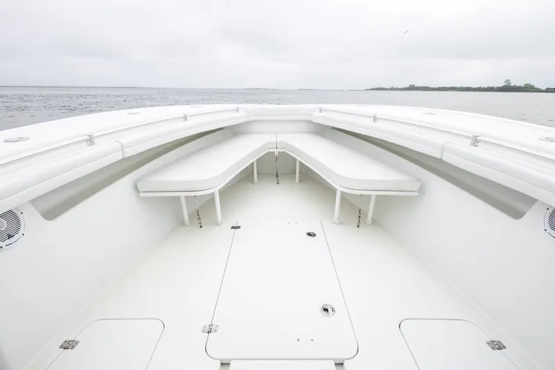 Slide: The Image of 2017 Yellowfin 32 Offshore boat interior with white seating and open deck. - 12