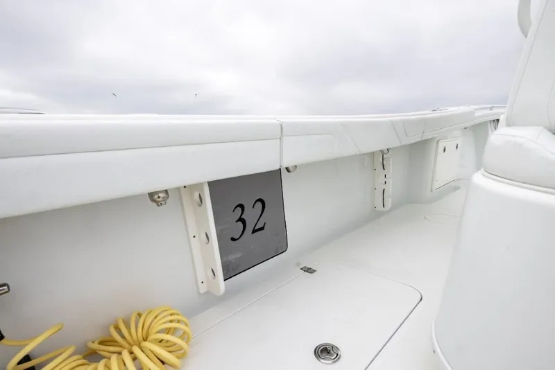 Slide: The Image of 2017 Yellowfin 32 Offshore boat interior with clean white deck and coiled yellow rope. - 14