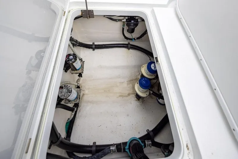 Slide: The Image of Bilge area of a 2017 Yellowfin 32 Offshore boat, showing pumps and hoses. - 15