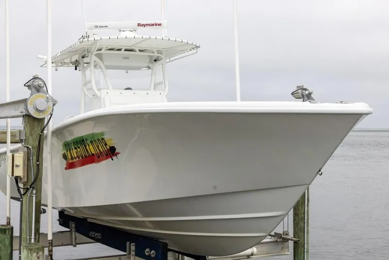 Slide: The Image of 2017 Yellowfin 32 Offshore boat docked, featuring sleek design and vibrant logo. - 4