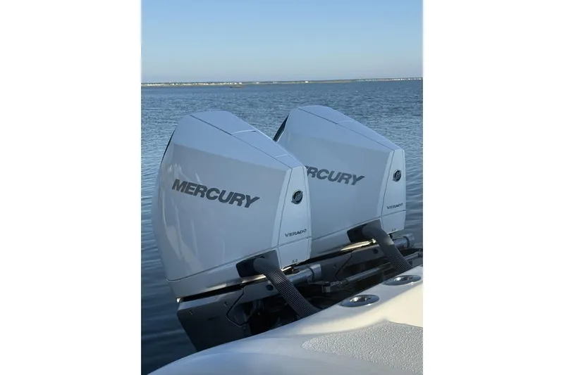 Slide: The Image of Twin Mercury Verado engines on a 2017 Yellowfin 32 Offshore boat, calm water background. - 5