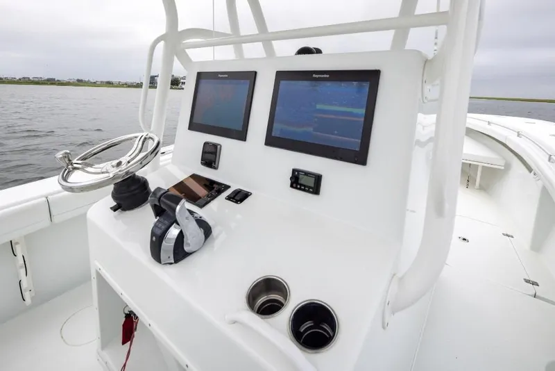 Slide: The Image of 2017 Yellowfin 32 Offshore boat console with dual screens and steering wheel. - 8