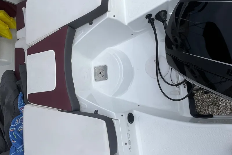 Slide: The Image of 2019 Tahoe 450 TF boat interior with seating and engine view. - 10