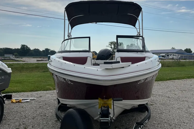 Slide: The Image of 2019 Tahoe 450 TF boat on trailer, parked outdoors, with canopy and open windshield. - 3
