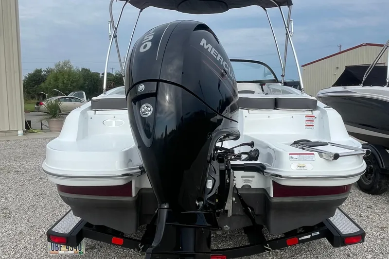 Slide: The Image of 2019 Tahoe 450 TF boat with Mercury outboard motor, parked on gravel. - 4