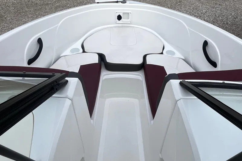 Slide: The Image of 2019 Tahoe 450 TF boat interior with white and maroon seating, cup holders, and grab handles. - 6