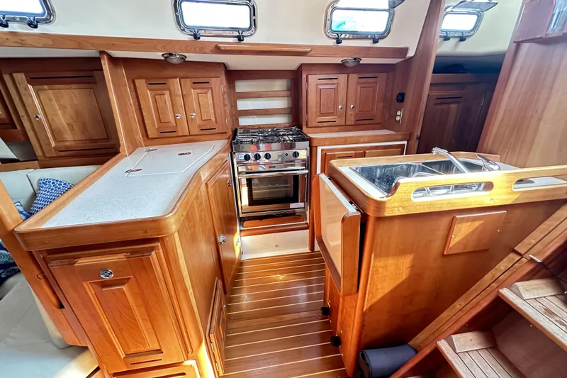 Slide: The Image of Interior of 2015 Tartan 3700 CCR yacht with wooden cabinetry and modern kitchen amenities. - 6