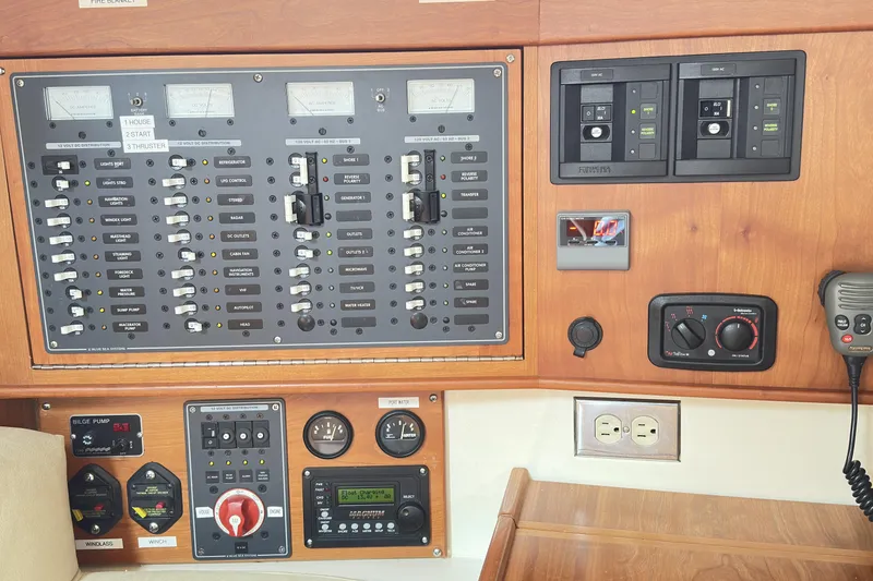 Slide: The Image of Control panel of a 2015 Tartan 3700 CCR yacht with various switches and gauges. - 7