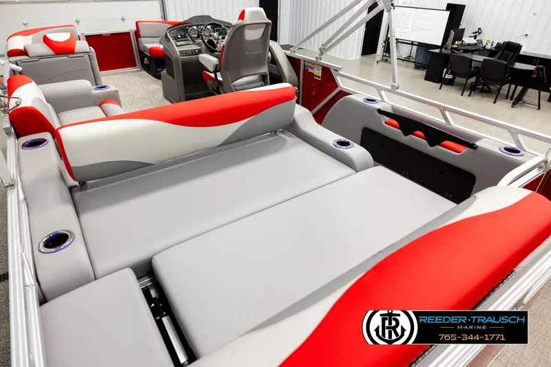 Slide: The Image of 2026 Avalon LSZ Vrl boat interior with red and gray seating, cup holders, and steering console. - 11