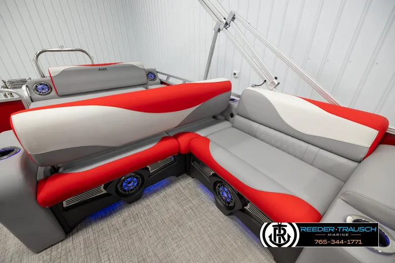 Slide: The Image of 2026 Avalon LSZ Vrl boat interior with red and gray seating, featuring modern design and speakers. - 21
