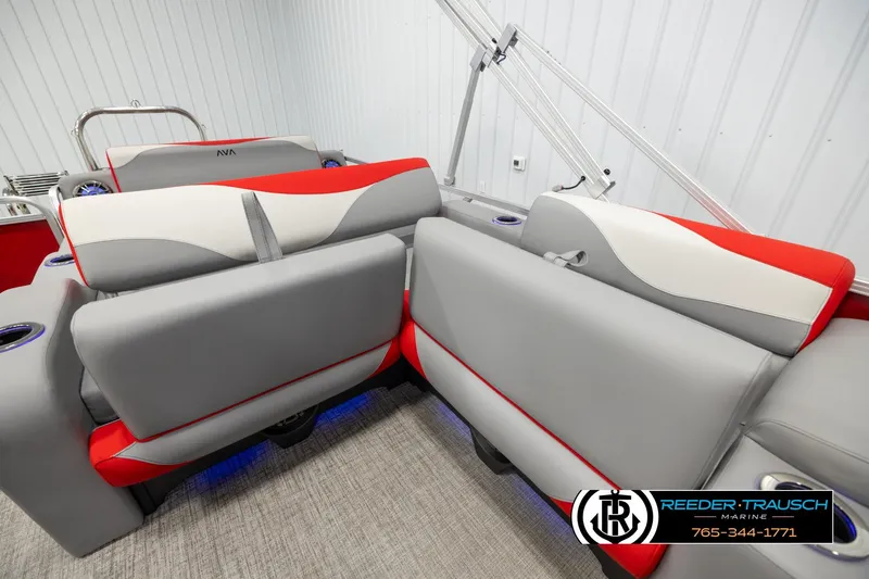 Slide: The Image of 2026 Avalon LSZ Vrl boat interior with gray and red seating, cup holders, and blue LED lighting. - 22