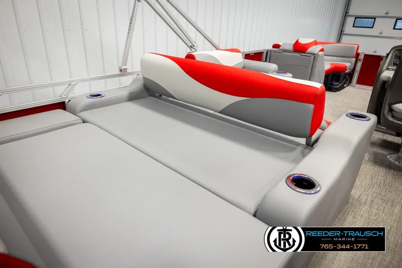 Slide: The Image of 2026 Avalon LSZ Vrl boat interior with red and gray seating, cup holders, and modern design. - 23