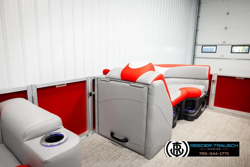 Slide: The Image of 2026 Avalon LSZ Vrl pontoon boat interior with red and gray seating, cup holders, and modern design. - 27