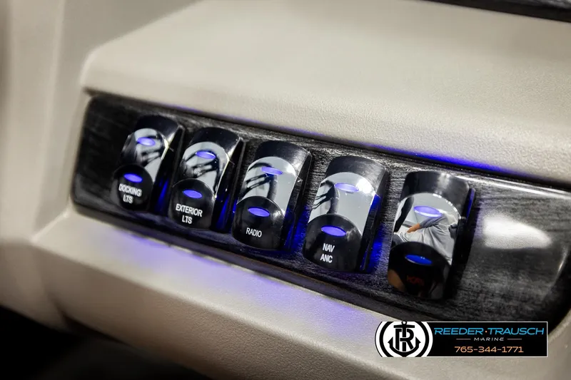 Slide: The Image of Control panel of 2026 Avalon LSZ Vrl with illuminated switches for docking, exterior lights, and radio. - 38