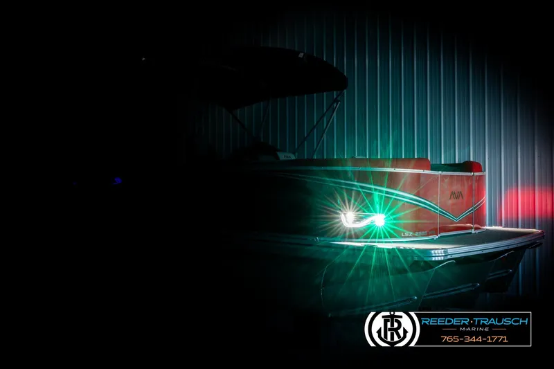 Slide: The Image of 2026 Avalon LSZ Vrl boat with illuminated lights in a dimly lit setting. - 4