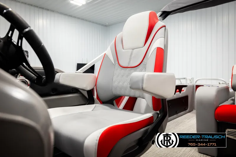 Slide: The Image of 2026 Avalon LSZ Vrl boat interior with red and gray seating, steering wheel, and armrests. - 40