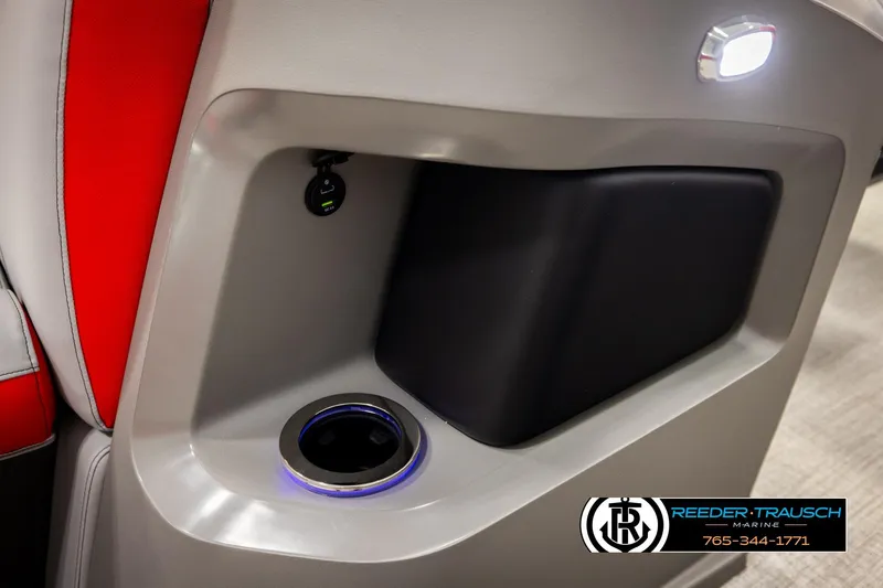 Slide: The Image of 2026 Avalon LSZ Vrl boat interior with cup holder and USB port, featuring red and gray seating. - 44