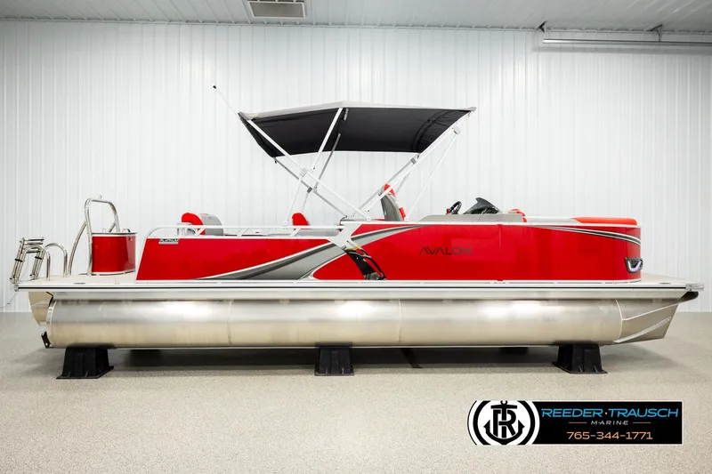 Slide: The Image of 2026 Avalon LSZ Vrl pontoon boat, red with black canopy, displayed indoors. - 5