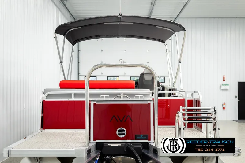 Slide: The Image of 2026 Avalon LSZ Vrl pontoon boat in showroom, featuring red and silver design. - 7