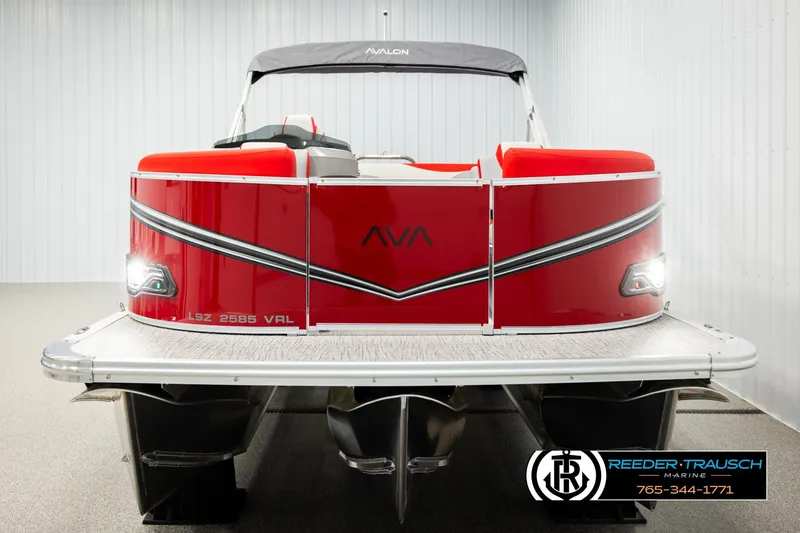 Slide: The Image of 2026 Avalon LSZ Vrl pontoon boat, red exterior, displayed indoors. - 8