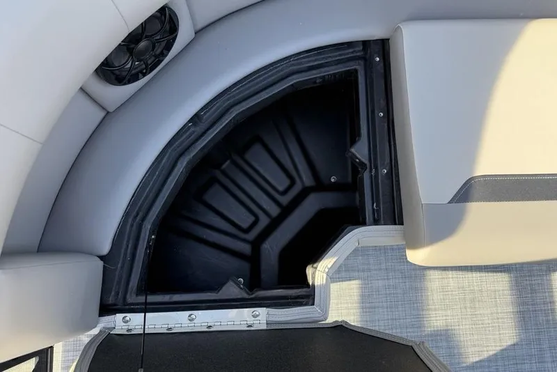 Slide: The Image of Storage compartment in 2026 Premier 220 Sunscape RF boat, featuring sleek seating and speaker. - 11