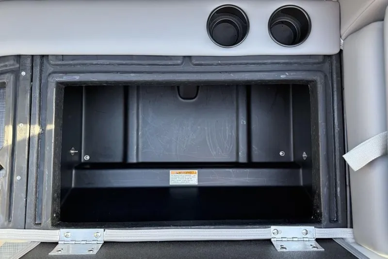 Slide: The Image of Storage compartment in 2026 Premier 220 Sunscape RF boat, featuring dual cup holders. - 19