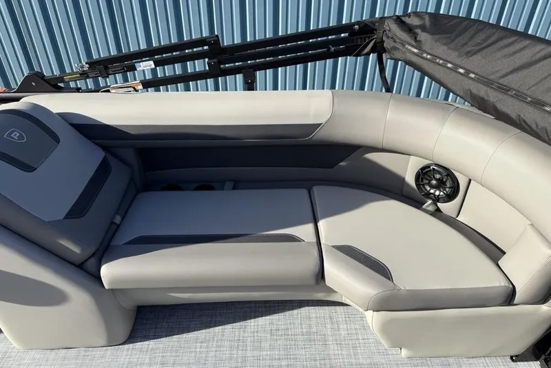 Slide: The Image of 2026 Premier 220 Sunscape RF boat interior with gray seating and speaker. - 20