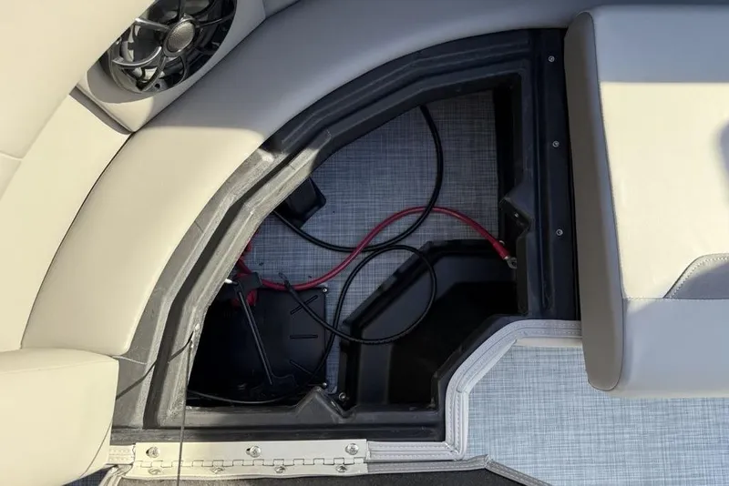 Slide: The Image of Open storage compartment in 2026 Premier 220 Sunscape RF boat with visible wiring. - 21