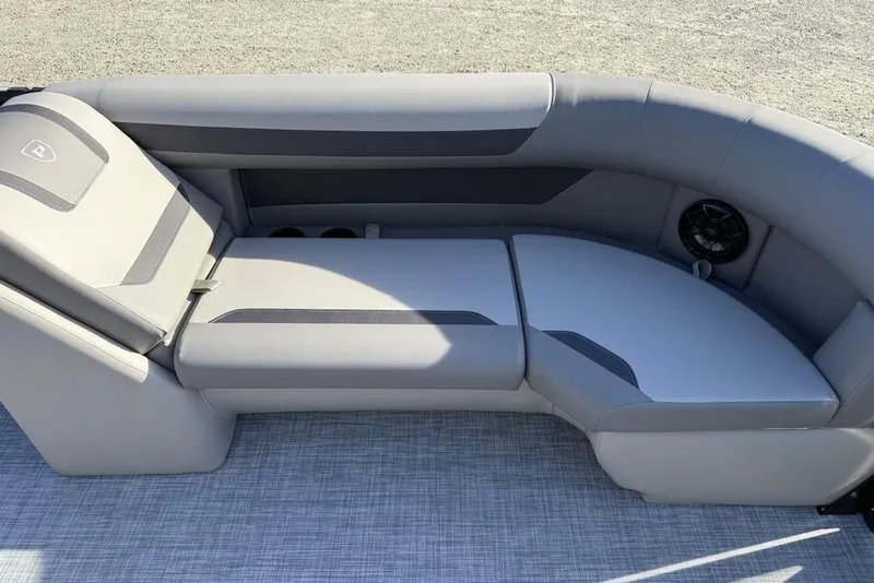 Slide: The Image of 2026 Premier 220 Sunscape RF boat interior with gray cushioned seating and speaker. - 5