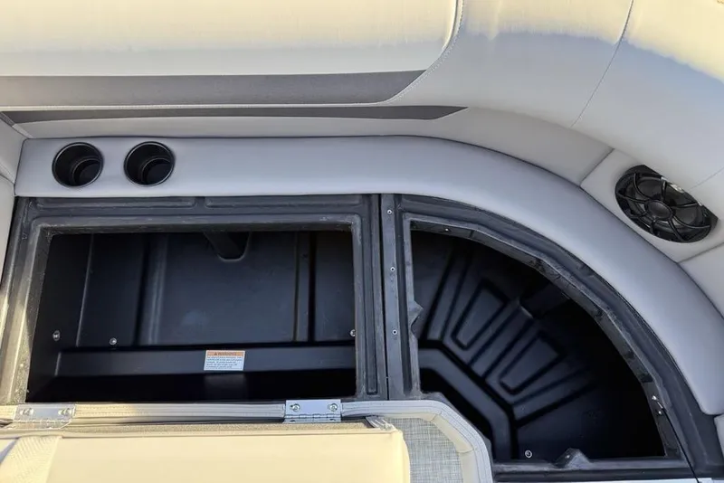 Slide: The Image of Interior storage compartment of 2026 Premier 220 Sunscape RF boat with cup holders. - 8