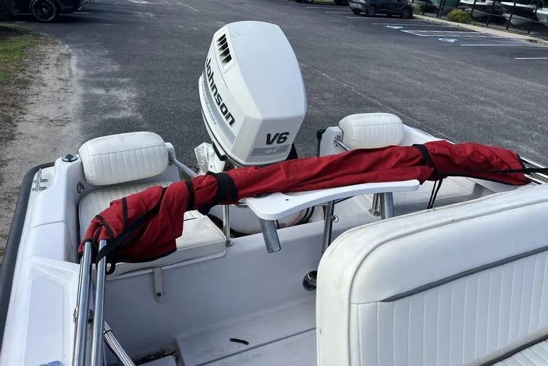 Slide: The Image of 1997 Boston Whaler Outrage 17 with Johnson V6 engine, parked in a lot. - 12