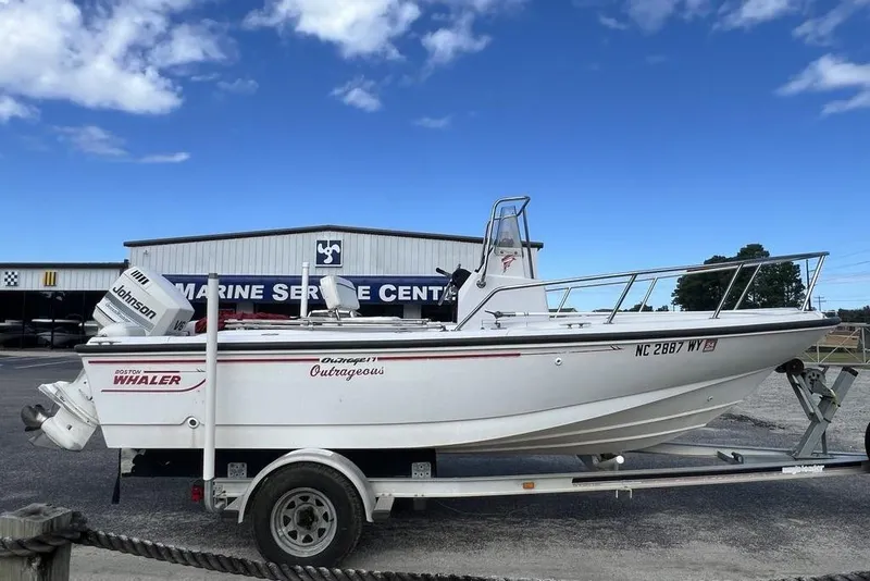 Slide: The Image of 1997 Boston Whaler Outrage 17 boat on trailer at marine service center. - 3