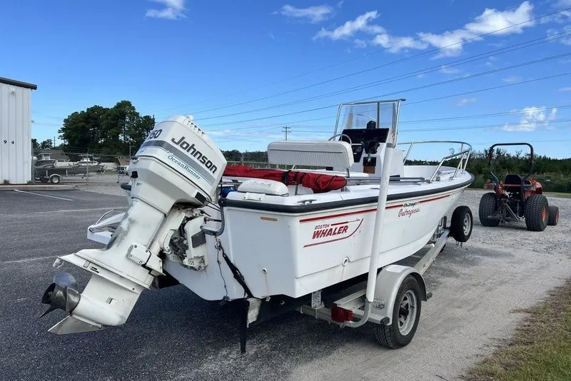 Slide: The Image of 1997 Boston Whaler Outrage 17 boat on trailer with Johnson outboard motor. - 5