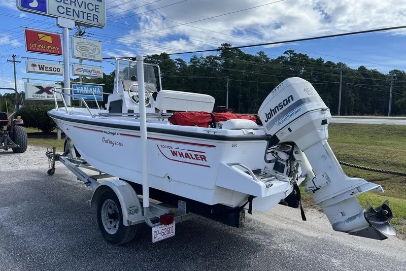 Slide: The Image of 1997 Boston Whaler Outrage 17 boat with Johnson outboard motor on a trailer. - 6
