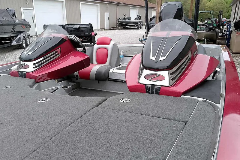 Slide: The Image of 2015 Ranger Z521C Ranger Cup Equipped boat with red and gray seating, parked outdoors. - 10