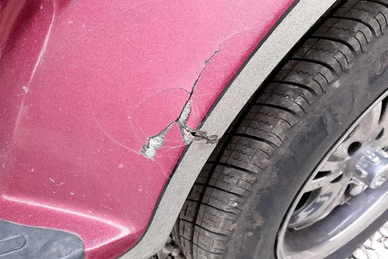 Slide: The Image of Cracked fender on 2015 Ranger Z521C Ranger Cup Equipped, showing tire and damage detail. - 11