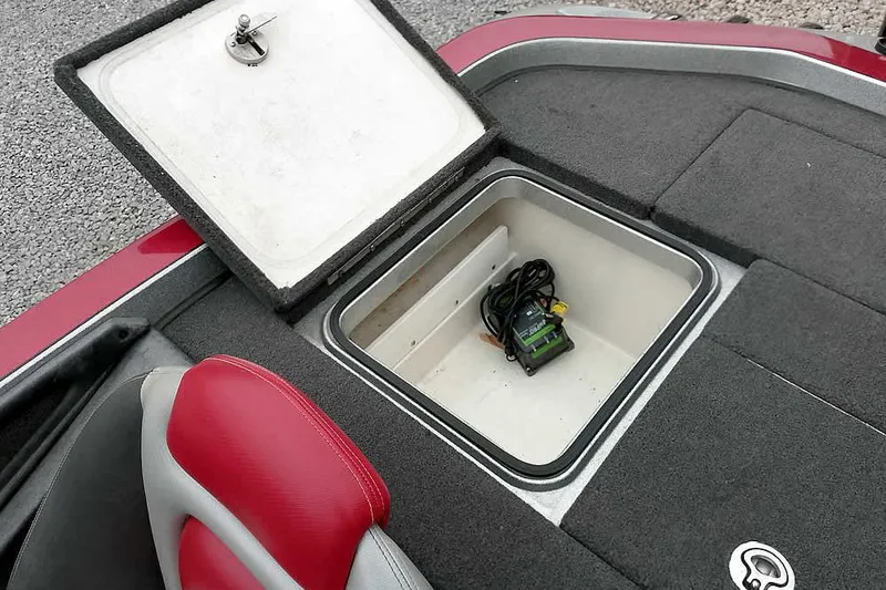 Slide: The Image of 2015 Ranger Z521C storage compartment with charger, red and gray seating, open hatch. - 40