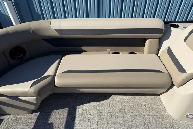Slide: The Image of 2026 Premier 220 Sunscape RF XLC boat interior with beige seating and cup holders. - 10
